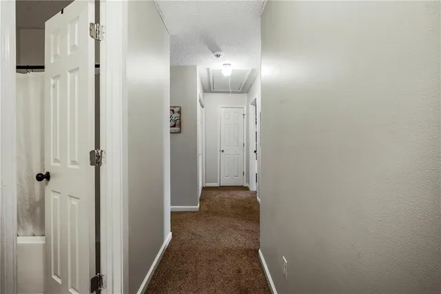 a living room with furniture a rug and a bookshelf