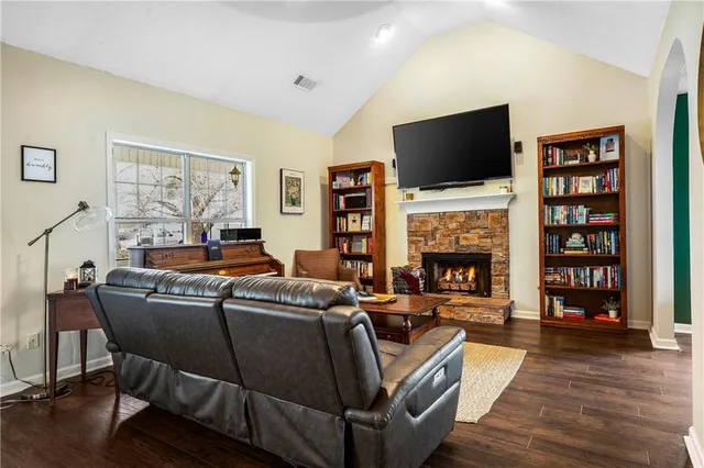a living room with furniture a flat screen tv and a fireplace