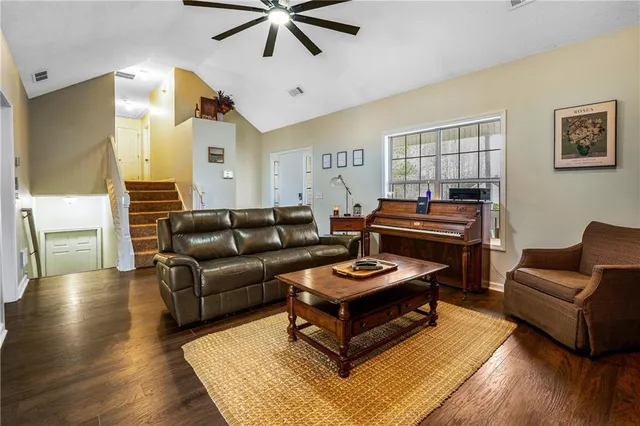 a living room with furniture and a wooden floor
