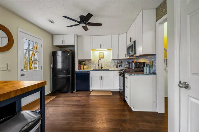 a kitchen with stainless steel appliances a refrigerator stove microwave and cabinets