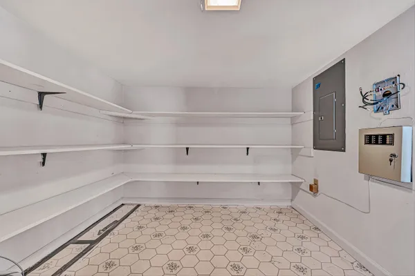 a view of staircase with white walls and white door