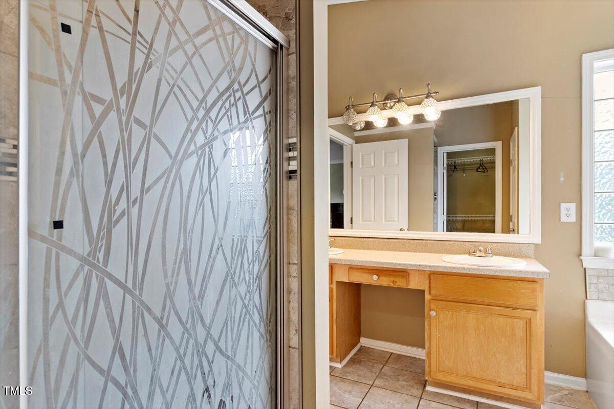5121 Amberfield Way Raleigh, NC 27604 - Photo 19 of 27 a bathroom with a sink and a mirror