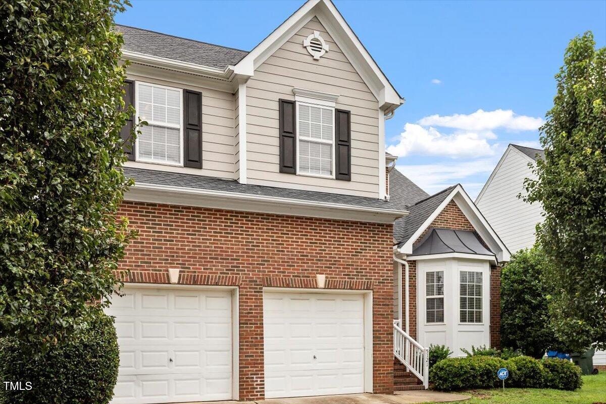 5121 Amberfield Way Raleigh, NC 27604 - Photo 3 of 27 a front view of a house with a yard and garage