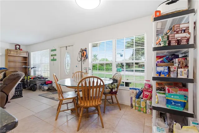 a kitchen with stainless steel appliances granite countertop a refrigerator a stove a sink a stove and white cabinets