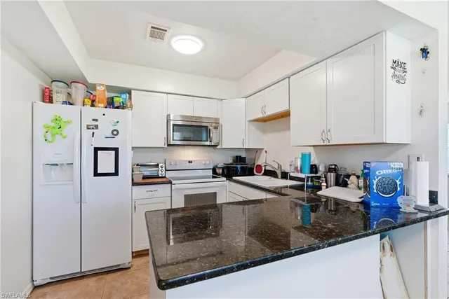 a kitchen with cabinets stainless steel appliances a sink and dishwasher