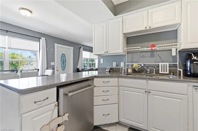 a kitchen with cabinets appliances and a sink
