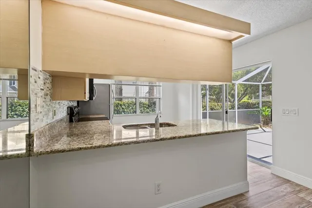a kitchen with kitchen island a sink and a large window