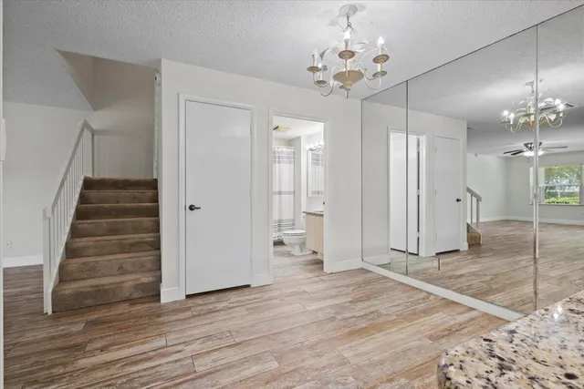 a view of a chandelier fan and wooden floor