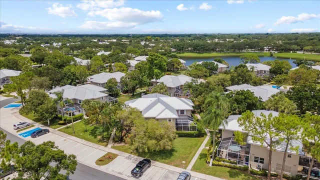 an aerial view of residential houses with outdoor space and lake view