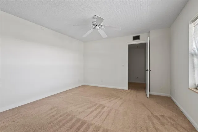 a bathroom with a granite countertop sink a mirror and a shower