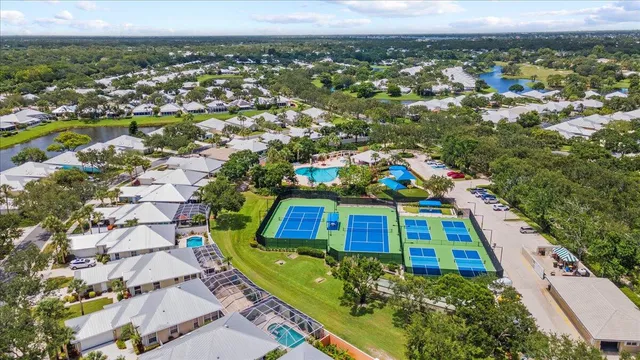 an aerial view of a swimming pool with outdoor seating and yard