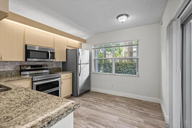 a kitchen with a refrigerator stove and microwave