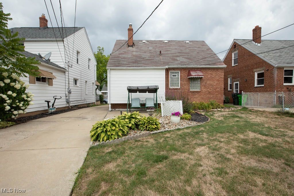 12822 Grannis Road Cleveland, OH 44125 - Photo 44 of 44 Back of property with a patio area, a lawn, and a pergola