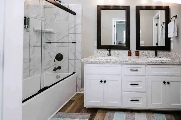 a bathroom with a double vanity sink and mirror