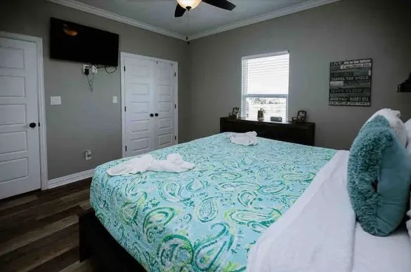 a bedroom with a bed and a flat tv screen