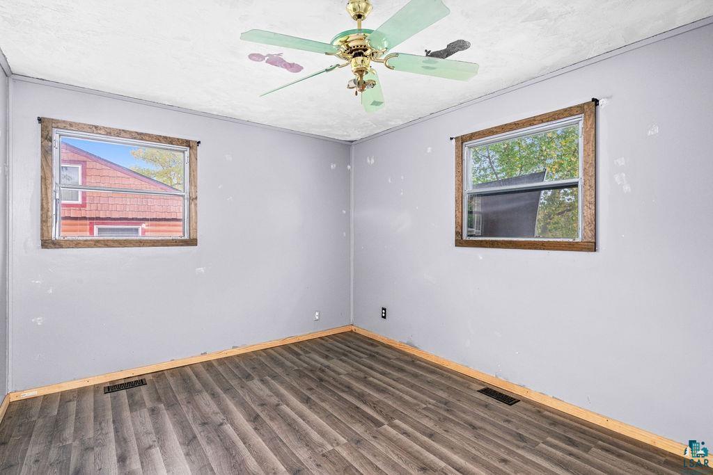 66 Banks Boulevard Silver Bay, MN 55614 - Photo 12 of 19 Unfurnished room featuring dark wood-type flooring and ceiling fan