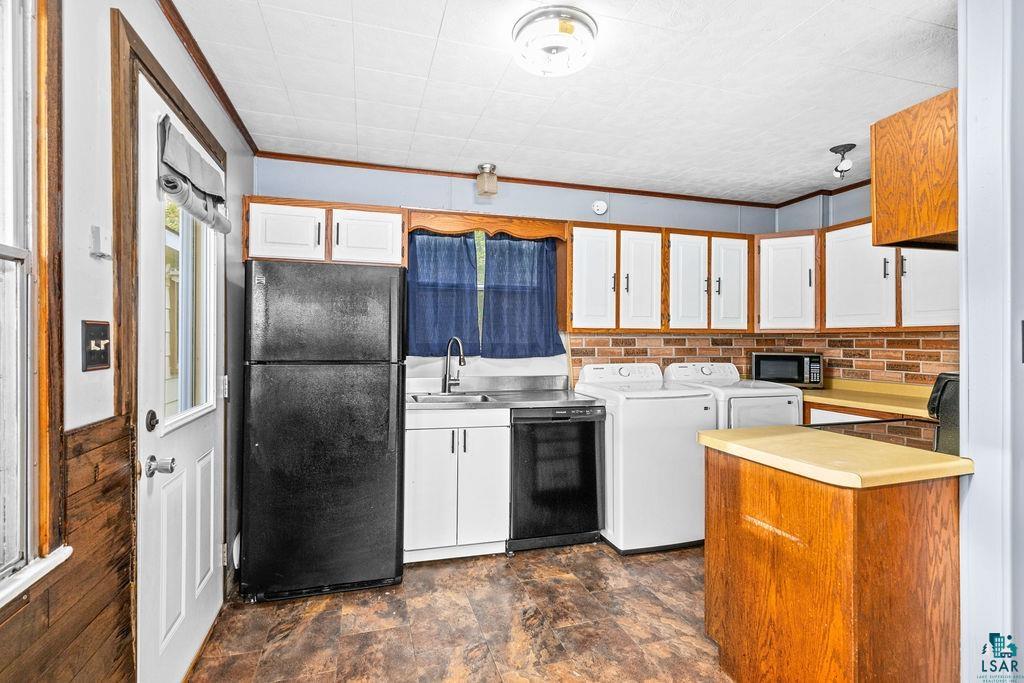 66 Banks Boulevard Silver Bay, MN 55614 - Photo 3 of 19 Kitchen with light countertops, white cabinets, black appliances, ornamental molding, and brown cabinets