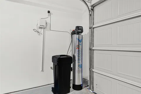 a view of storage and utility room with closet