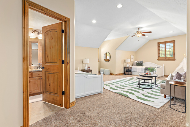 552 East Johns Way Sandy, UT 84070 - Photo 37 of 67 Sloped ceilings, recessed lighting, ceiling fan, natural wood door, and an attached bathroom with a vanity and sconce lighting