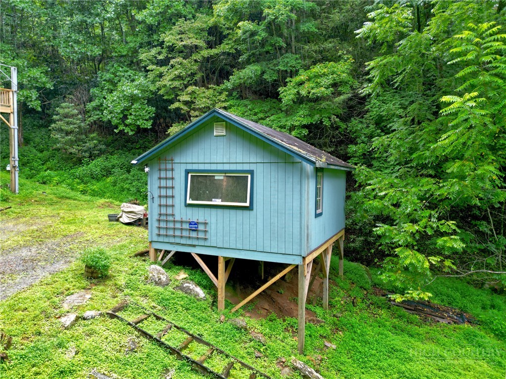 9440 Blackberry Road Lenoir, NC 28645 - Photo 27 of 30 a view of a backyard with a small cabin