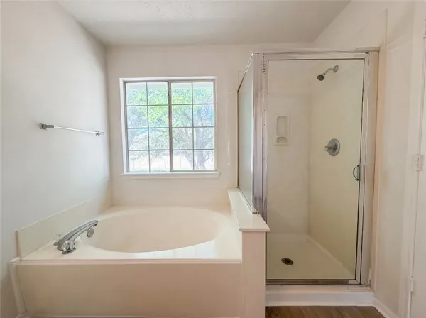 a white bath tub sitting next to a shower