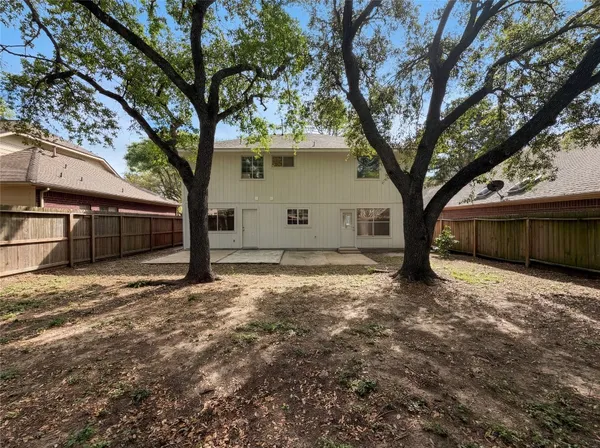 a view of a house with a tree in the background