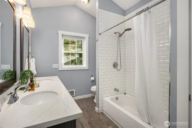 a bathroom with a tub a sink and a large mirror
