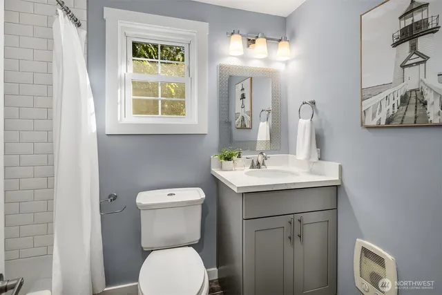 a bathroom with a toilet sink and mirror