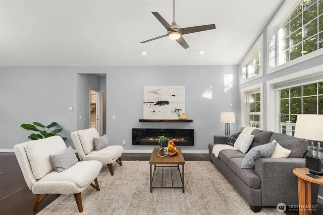 a living room with furniture a fireplace and window