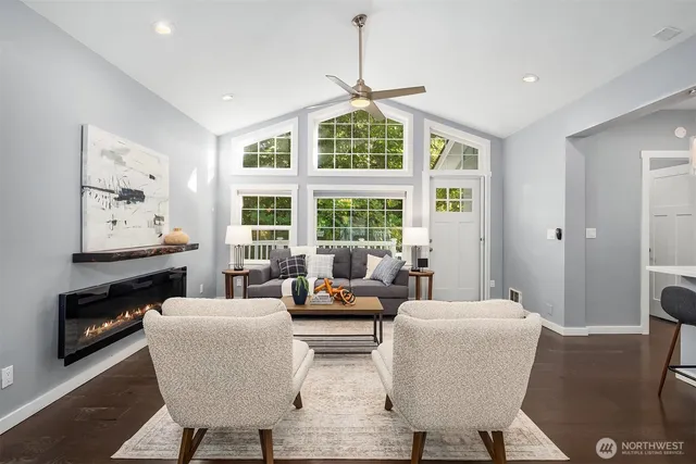a living room with furniture fireplace and a window