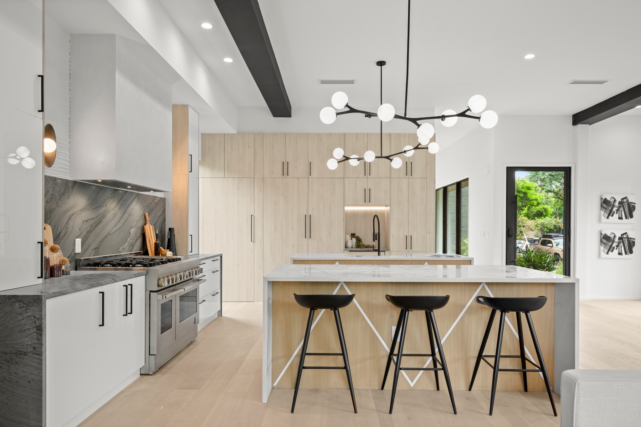 2215 South 3rd Street Austin, TX 78704 - Photo 7 of 38 a kitchen with stainless steel appliances a kitchen island a stove a table and chairs in it