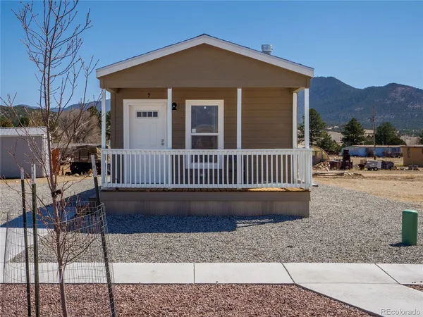 a view of a house with a deck and a yard