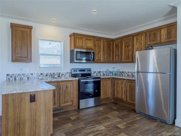 a kitchen with a refrigerator sink and microwave