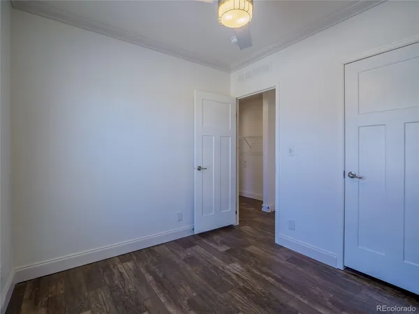a view of an empty room and wooden floor