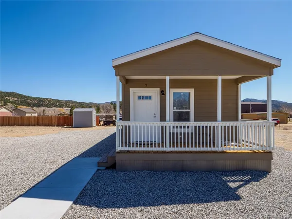 a front view of a house with wooden deck