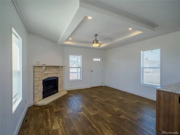 a view of empty room with wooden floor and fireplace