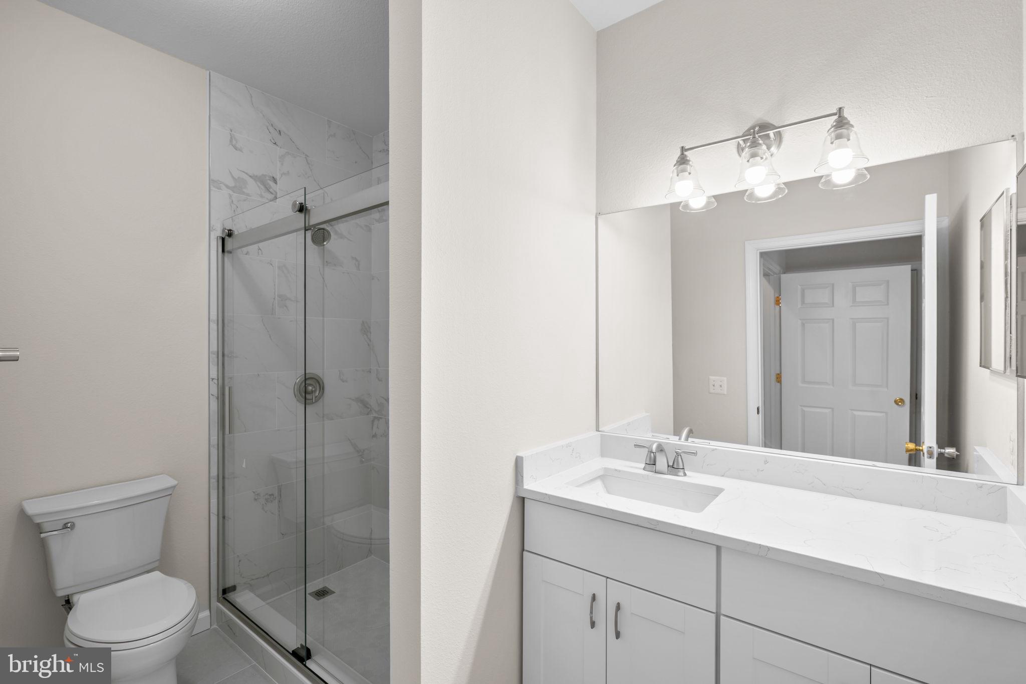 1570 Spring Gate Dr., Unit 7303 McLean, VA 22102 - Photo 16 of 25 a bathroom with a toilet a sink and mirror