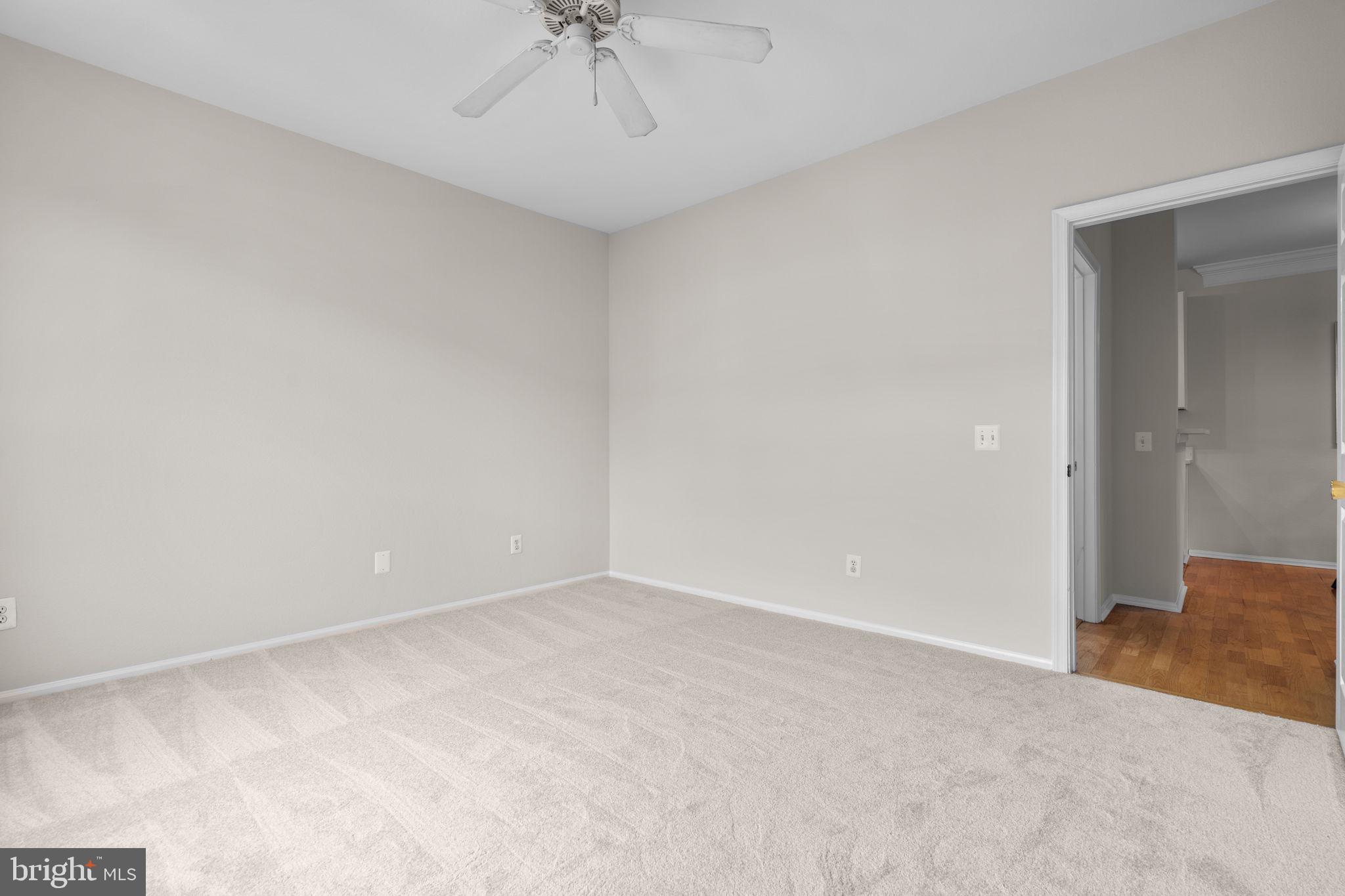 1570 Spring Gate Dr., Unit 7303 McLean, VA 22102 - Photo 20 of 25 a view of an empty room with a chandelier fan