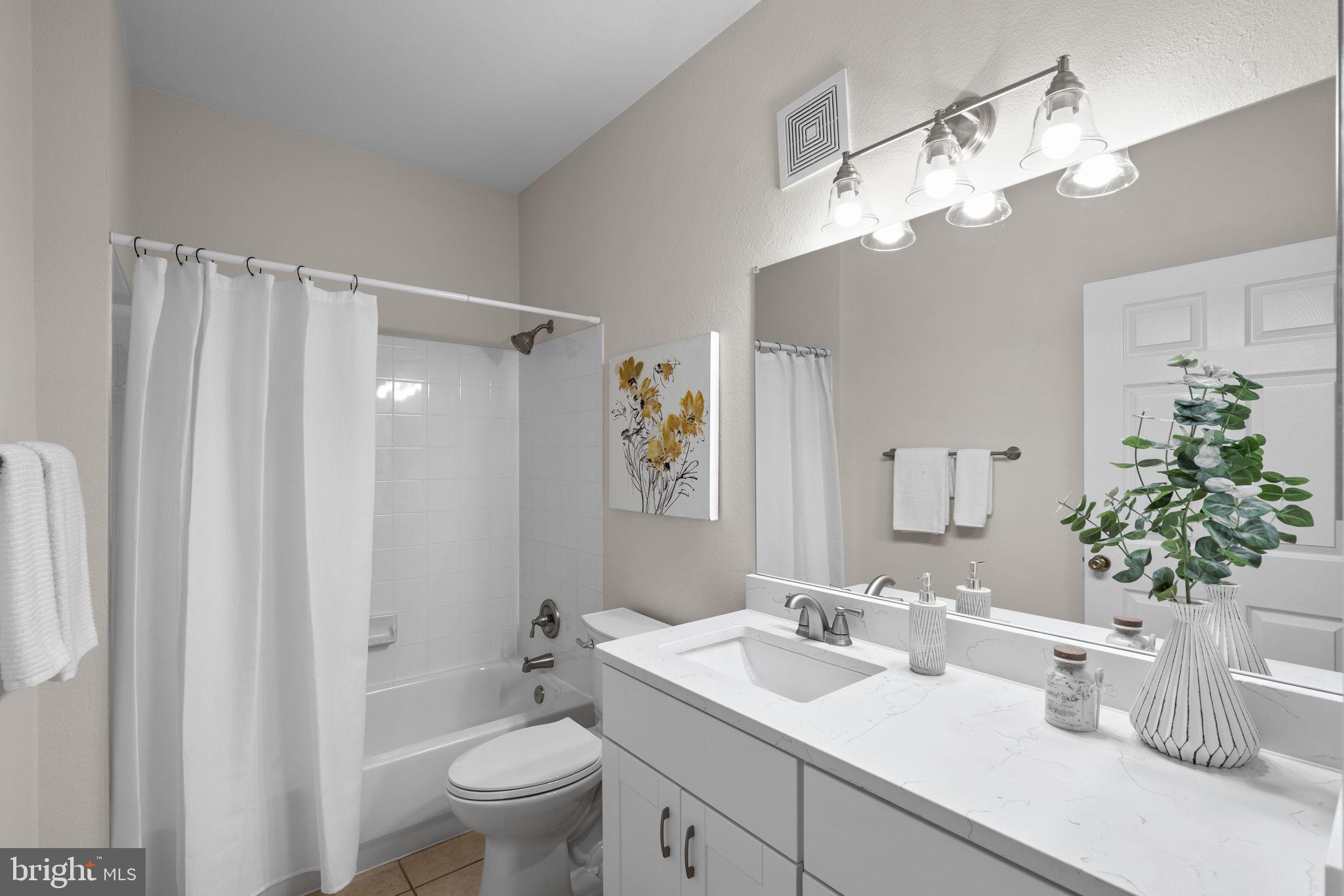 1570 Spring Gate Dr., Unit 7303 McLean, VA 22102 - Photo 22 of 25 a bathroom with a sink a toilet and a large mirror