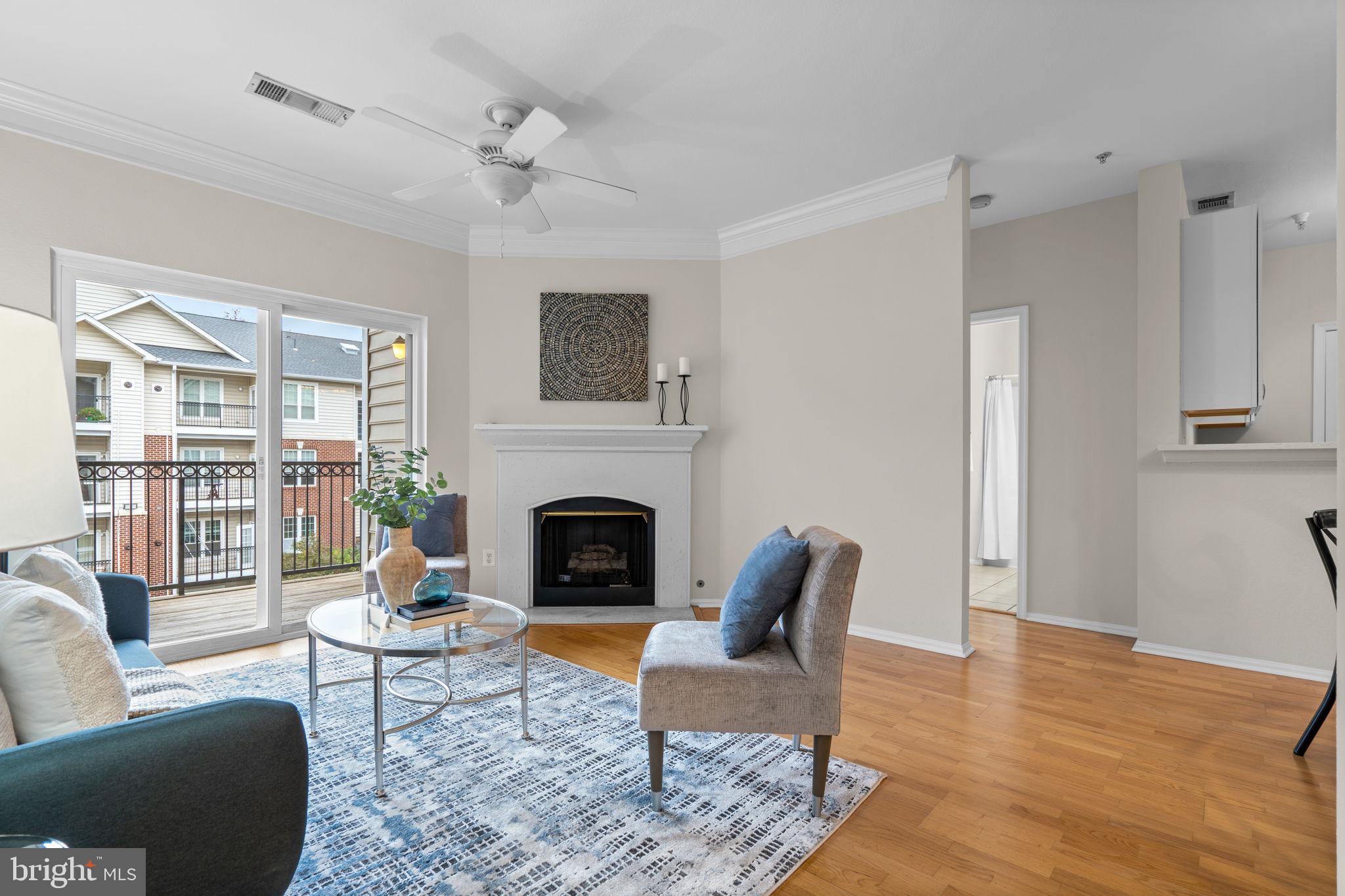 1570 Spring Gate Dr., Unit 7303 McLean, VA 22102 - Photo 5 of 25 a living room with furniture and a fireplace