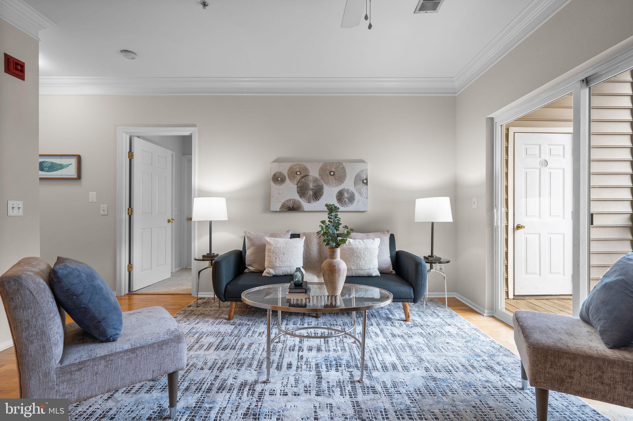 1570 Spring Gate Dr., Unit 7303 McLean, VA 22102 - Photo 7 of 25 a living room with furniture a rug and a table