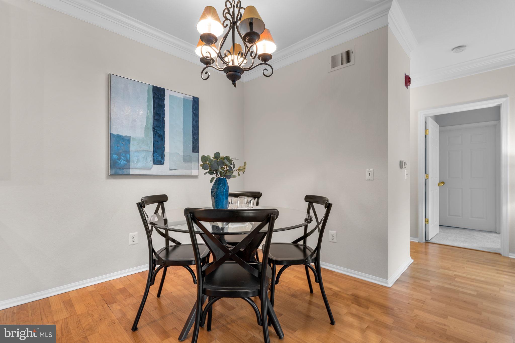 1570 Spring Gate Dr., Unit 7303 McLean, VA 22102 - Photo 8 of 25 a view of a dining room with furniture and chandelier