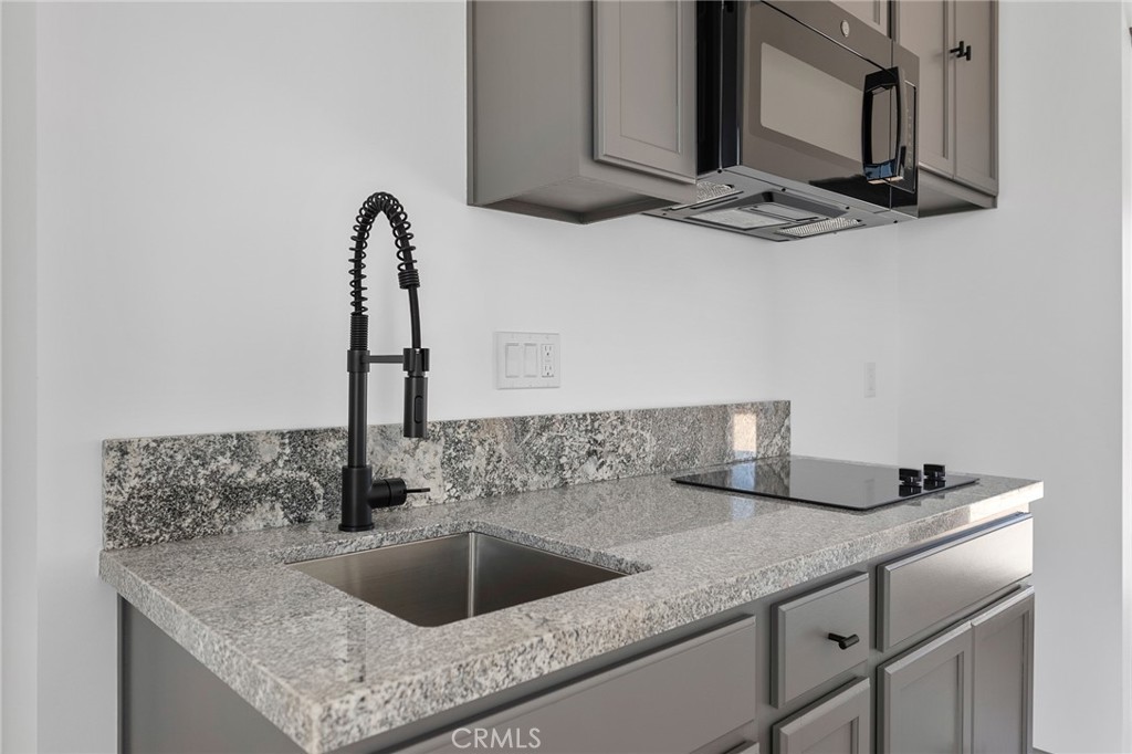 5090 1st Street East Joshua Tree, CA 92252 - Photo 5 of 12 a kitchen with a sink and cabinets