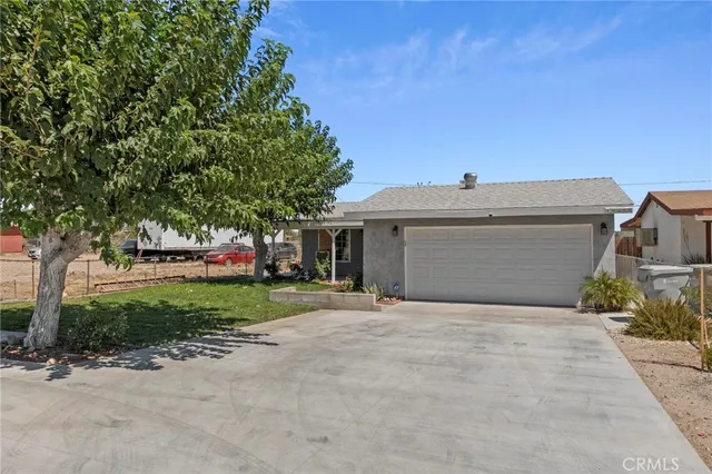 a front view of a house with a yard and a garage