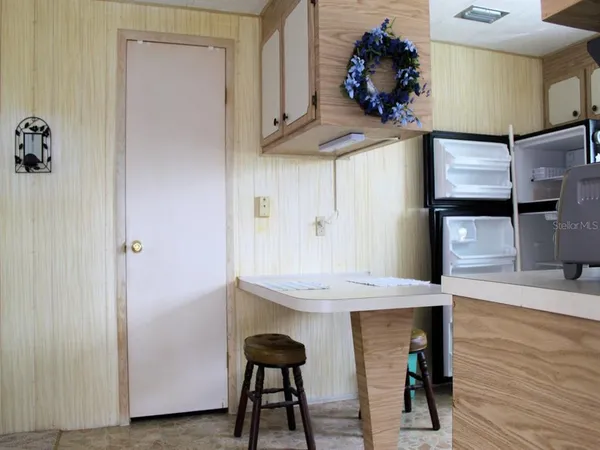 a kitchen with a stove and a white cabinets