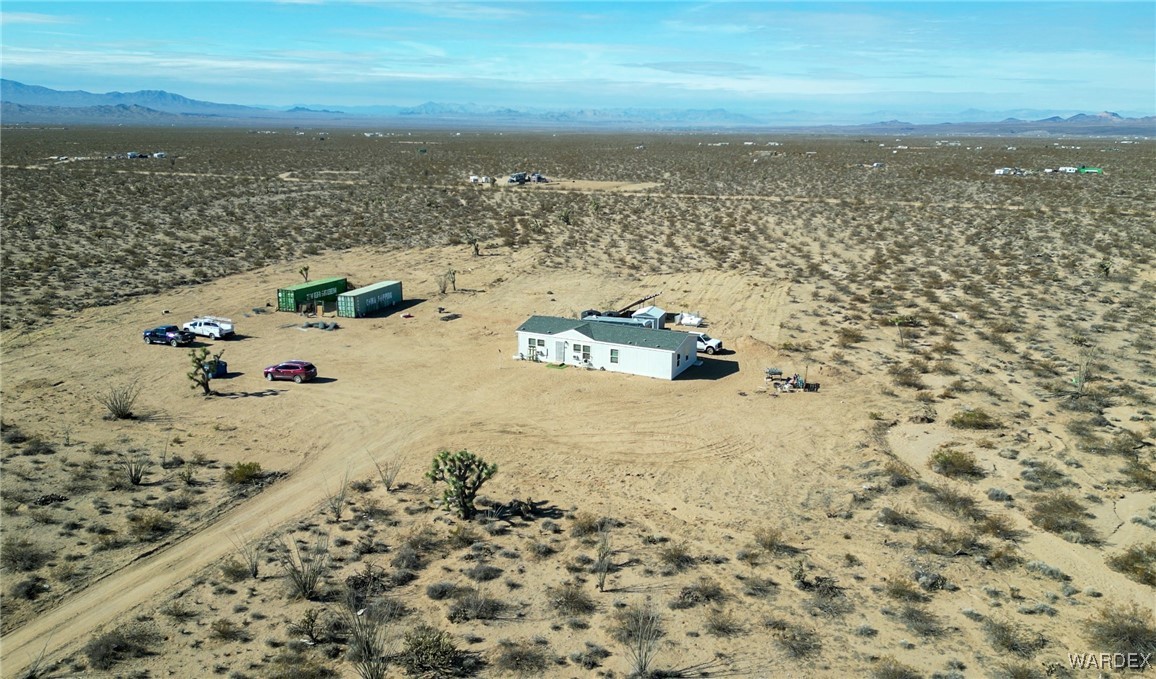 15333 South Doc Holliday Road Yucca, AZ 86438 - Photo 10 of 15 Drone / aerial view featuring view of desert, a rural view, and a mountain view
