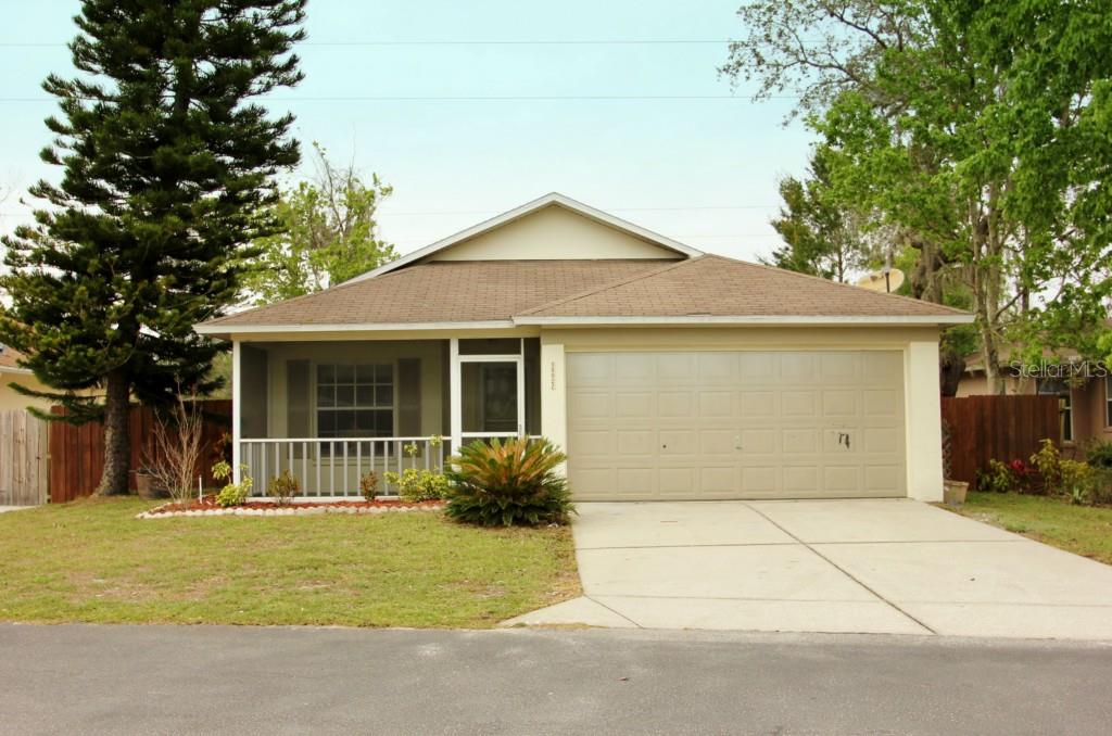 11027 Kenmore Drive New Port Richey, FL 34654 - Photo 1 of 1 a house with trees in the background