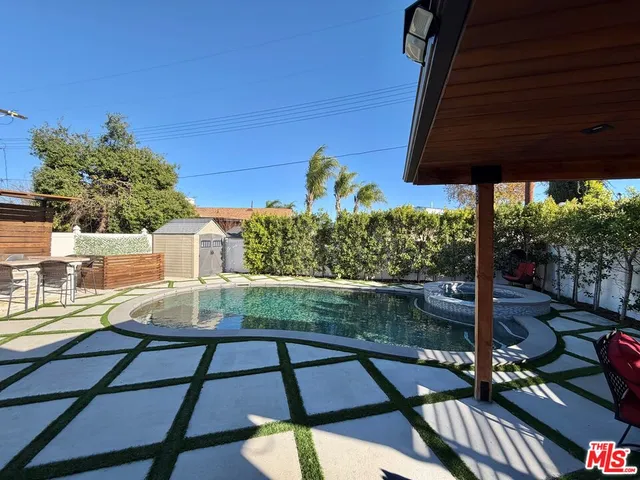 a view of a patio with table and chairs potted plants with wooden floor and outdoor seating