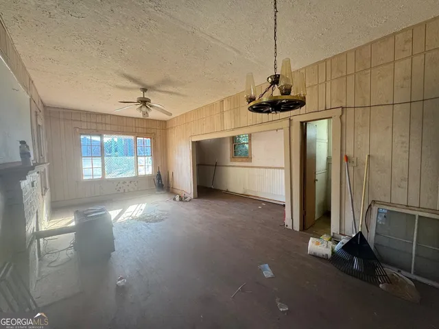 a room with a window and a ceiling fan