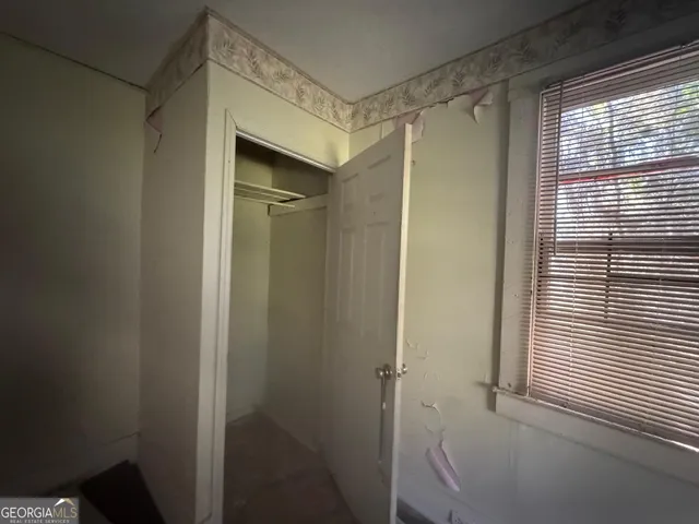 a view of an empty room and a window